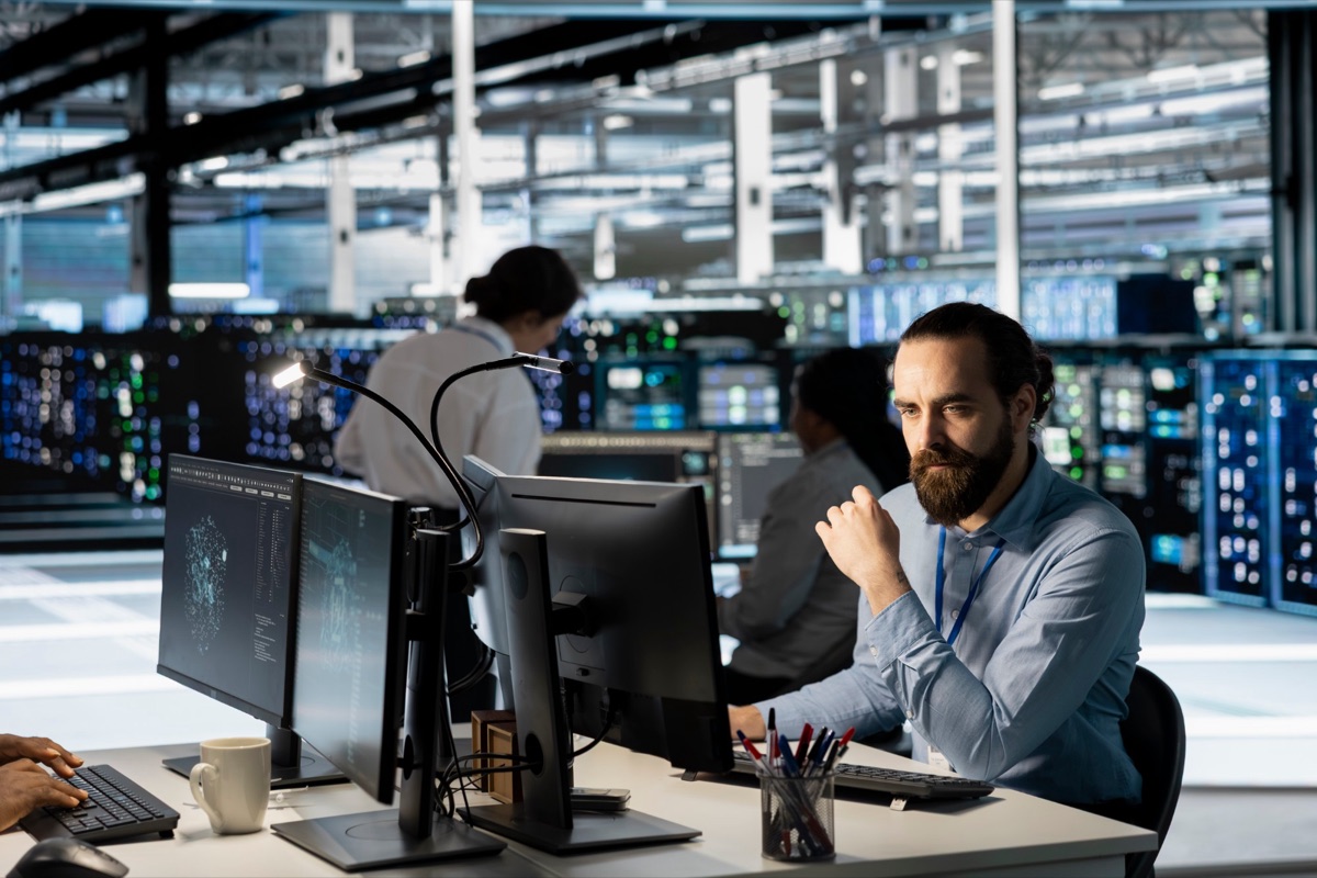 Engineers at their desks in a modern data center